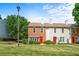 Charming townhome with a well-manicured lawn and a vibrant red door at 197 Holcomb Ferry Rd, Roswell, GA 30076