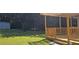 Spacious backyard featuring a wooden deck, a fire pit, and a storage building at 2357 Whitehouse Rd, Dacula, GA 30019