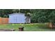 Wide backyard with lush lawn, storage shed, wood fire pit, and ample room for outdoor entertainment at 2357 Whitehouse Rd, Dacula, GA 30019