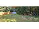 Spacious backyard with lush lawn, storage shed, fire pit, and ample space for outdoor activities at 2357 Whitehouse Rd, Dacula, GA 30019