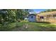 Expansive backyard with a deck, shed, mature trees, and a birdbath, offering a private outdoor retreat at 2357 Whitehouse Rd, Dacula, GA 30019