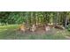 Secluded seating area in a wooded backyard, perfect for outdoor relaxation and entertaining at 2357 Whitehouse Rd, Dacula, GA 30019