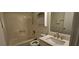 Bathroom featuring a combined shower and tub, sleek vanity, and storage shelving at 2357 Whitehouse Rd, Dacula, GA 30019