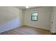 Bedroom with hardwood floors and a window, offers a simple design at 2357 Whitehouse Rd, Dacula, GA 30019