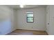 Bedroom with hardwood floors and a window, features a simple design at 2357 Whitehouse Rd, Dacula, GA 30019