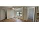 Bright dining area features natural light and modern wood-look flooring, adjacent to the kitchen and entryways at 2357 Whitehouse Rd, Dacula, GA 30019