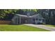 Single-story home with covered parking, front porch, and attractive landscaping at 2357 Whitehouse Rd, Dacula, GA 30019