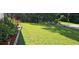 Beautifully landscaped front yard with flowers and lush green grass at 2357 Whitehouse Rd, Dacula, GA 30019
