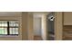 Hallway with neutral walls and modern flooring, connecting various rooms and offering a glimpse of the outdoor deck at 2357 Whitehouse Rd, Dacula, GA 30019