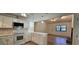 Modern kitchen with white cabinetry, stainless steel appliances, and an open view to living area at 2357 Whitehouse Rd, Dacula, GA 30019