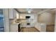 Modern kitchen with white cabinets, countertops, stainless steel appliances, and a stylish backsplash at 2357 Whitehouse Rd, Dacula, GA 30019