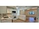 Modern kitchen with white cabinets, stone countertops, and an eat-in kitchen open to the living room at 2357 Whitehouse Rd, Dacula, GA 30019