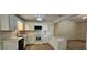 Updated kitchen featuring white cabinetry, modern appliances, countertop island, and stylish lighting at 2357 Whitehouse Rd, Dacula, GA 30019