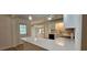 Well-lit kitchen with quartz countertops, stainless steel appliances, and white cabinetry at 2357 Whitehouse Rd, Dacula, GA 30019