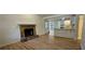 Open-concept living space with a stone fireplace and hardwood floors, flowing into the kitchen at 2357 Whitehouse Rd, Dacula, GA 30019