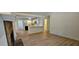 Bright living space with wood flooring, a stone fireplace, and an open view into the kitchen at 2357 Whitehouse Rd, Dacula, GA 30019