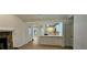 Comfortable living room featuring a stone fireplace and a view of the bright, updated kitchen at 2357 Whitehouse Rd, Dacula, GA 30019