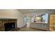 Inviting living room featuring a stone fireplace and a view of the bright, updated kitchen at 2357 Whitehouse Rd, Dacula, GA 30019