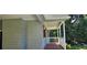 A cozy covered front porch featuring wood flooring and white columns at 2357 Whitehouse Rd, Dacula, GA 30019
