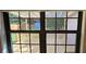 View through windows to a lovely backyard with a wooden deck, a shed, and lush greenery at 2357 Whitehouse Rd, Dacula, GA 30019
