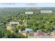 Aerial view of a home near Lake Lanier and Bald Ridge Marina, surrounded by lush greenery in Cumming, GA at 2560 Fairlane Dr, Cumming, GA 30041