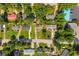 An aerial view of residential homes featuring well-manicured lawns and tree-lined streets in a neighborhood setting at 2560 Fairlane Dr, Cumming, GA 30041