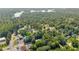 Aerial view featuring residential homes surrounded by lush greenery and a glimpse of Lake Lanier at 2560 Fairlane Dr, Cumming, GA 30041