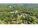 An aerial view showcasing a residential area with tree-lined streets and well-maintained homes at 2560 Fairlane Dr, Cumming, GA 30041