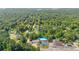 Aerial view of homes surrounded by lush greenery near the commercial areas in Cumming, GA at 2560 Fairlane Dr, Cumming, GA 30041