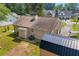 Backyard view featuring an outbuilding, lush green grass, and mature trees for added privacy at 2560 Fairlane Dr, Cumming, GA 30041