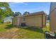 Back view of house featuring an air conditioning unit and green grass at 2560 Fairlane Dr, Cumming, GA 30041
