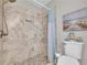 Updated bathroom with tiled shower, rainfall shower head, and modern fixtures at 2560 Fairlane Dr, Cumming, GA 30041