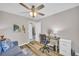 Cozy bedroom with ample natural light, ceiling fan, and comfortable work space at 2560 Fairlane Dr, Cumming, GA 30041