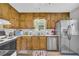 Kitchen featuring wood cabinets, stainless steel refrigerator, and modern appliances at 2560 Fairlane Dr, Cumming, GA 30041