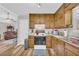 Bright kitchen with wood cabinets, stainless steel sink, and modern appliances at 2560 Fairlane Dr, Cumming, GA 30041