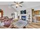 Cozy living room with a fireplace, hardwood floors, and access to kitchen and other rooms at 2560 Fairlane Dr, Cumming, GA 30041