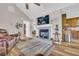 Comfortable living area featuring fireplace, hardwood floors, open to the kitchen for seamless entertaining at 2560 Fairlane Dr, Cumming, GA 30041