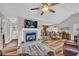 Spacious open-concept living room connected to kitchen and dining area with hardwood floors at 2560 Fairlane Dr, Cumming, GA 30041