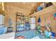 Organized shed space with shelves, storage containers, and a blue patterned rug, offering functional storage solutions at 2560 Fairlane Dr, Cumming, GA 30041
