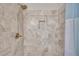 Close up of decorative, tiled walk-in shower showing shower head, tile inset and curtain at 2560 Fairlane Dr, Cumming, GA 30041