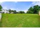 Expansive backyard with lush green lawn, shed, and white picket fence for privacy at 71 Barrington Dr, Hiram, GA 30141