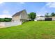 Side view of the house, backyard and shed featuring a well-manicured lawn on a sunny day at 71 Barrington Dr, Hiram, GA 30141