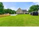 Large backyard, lush green lawn, shed, deck, and two-story house create an outdoor oasis at 71 Barrington Dr, Hiram, GA 30141