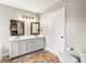 Bathroom featuring double sink vanity with white cabinets and tiled flooring at 71 Barrington Dr, Hiram, GA 30141