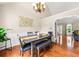 Bright dining room with a rustic table setting, hardwood floors, and tasteful artwork, perfect for entertaining guests at 71 Barrington Dr, Hiram, GA 30141