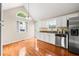 Bright kitchen features stainless steel appliances, white cabinetry, and hardwood floors at 71 Barrington Dr, Hiram, GA 30141