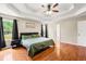 Spacious primary bedroom with large windows, hardwood floors, and tray ceilings at 71 Barrington Dr, Hiram, GA 30141