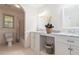 Clean bathroom featuring double sinks with marble countertops, white cabinets, and a shower/tub combination at 1402 Mclendon Dr, Decatur, GA 30033