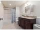 Updated bathroom featuring a vanity with dark wood cabinets and granite countertops at 1402 Mclendon Dr, Decatur, GA 30033