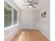 Bright bedroom features hardwood floors, a window, and a ceiling fan at 1402 Mclendon Dr, Decatur, GA 30033